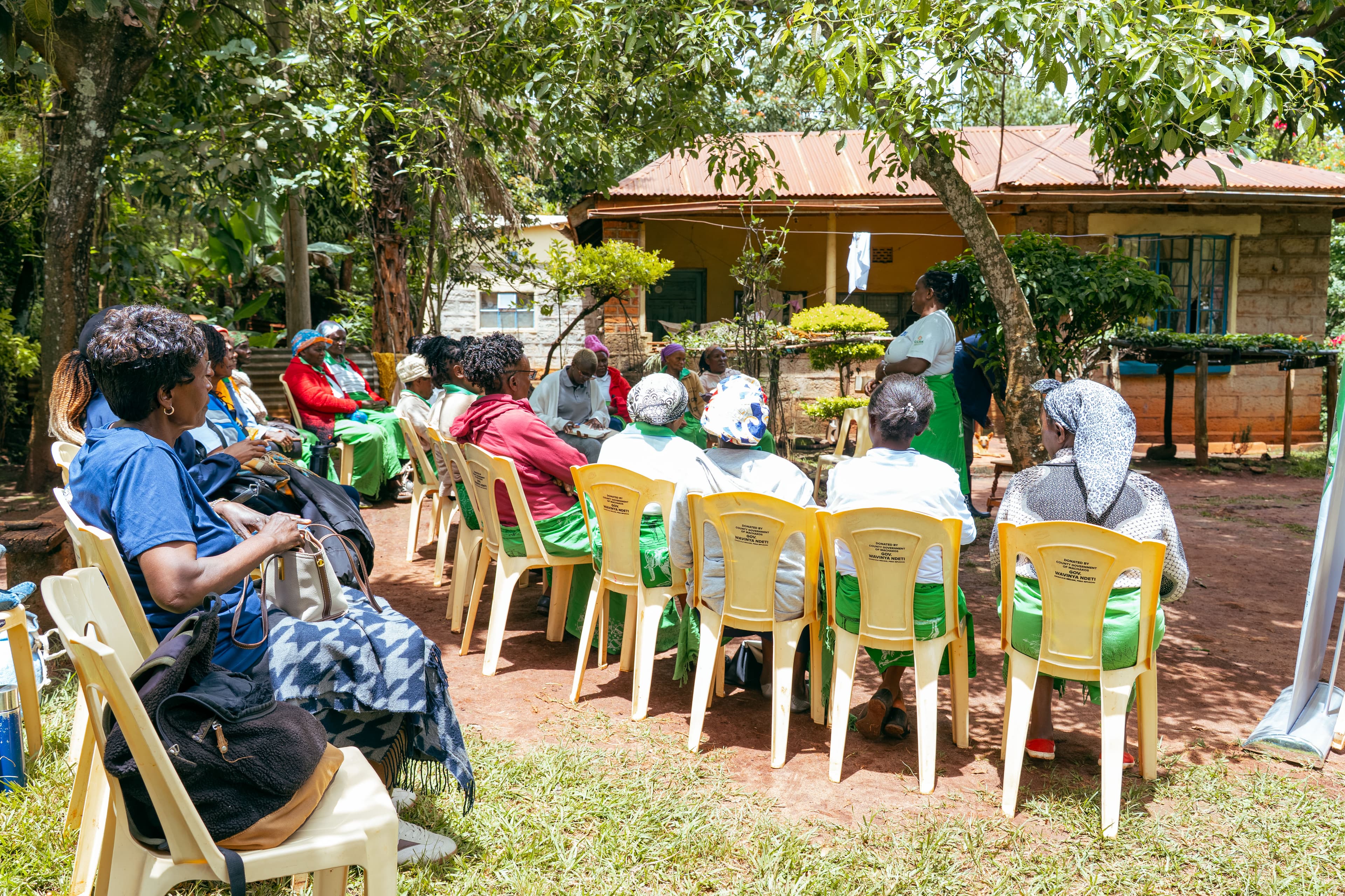 Donate page hero — authentic community imagery showing farmers, women leaders, youth engagement and agroecological activities in grassroots settings with dim atmospheric natural lighting and deep shadows